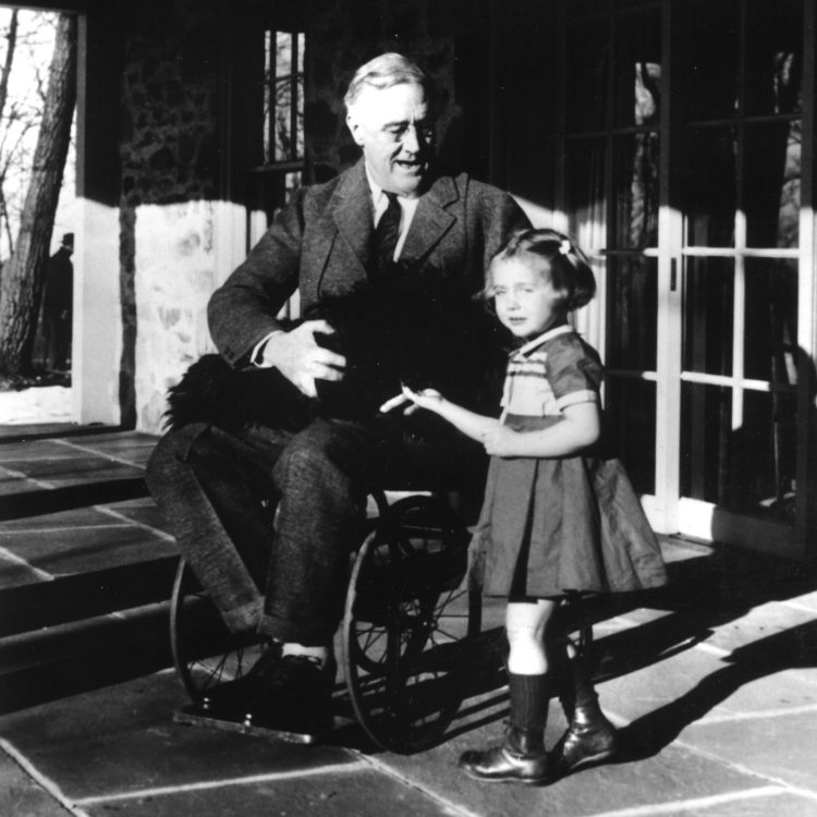 Presdent Franklin D. Roosevelt pictured here with his dog and granddaughter of a family friend. (Source: Landov)